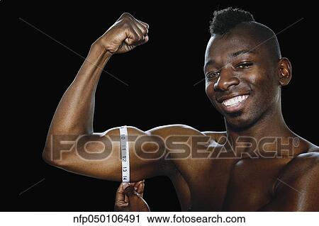 African man measuring flexed biceps View Large Photo Image Stock Image - African man measuring flexed biceps. Fotosearch