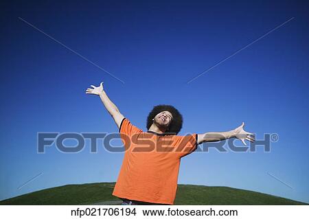 African man with arms raised under blue sky View Large Photo Image Picture - African man with arms raised under blue sky. Fotosearch