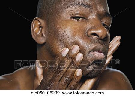 African man with hands on face View Large Photo Image Stock Photo - African man with hands on face. Fotosearch