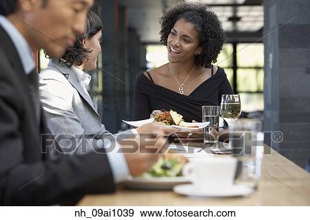 African waitress bringing food to businesswoman View Large Photo Image Stock Photo - African waitress bringing food to businesswoman. Fotosearch