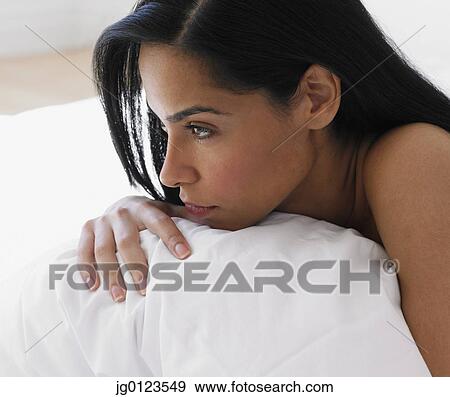 Stock Photo - African woman leaning on pillow. Fotosearch