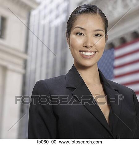 Asian businesswoman in front of American flag View Large Photo Image Stock Image - Asian businesswoman in front of American flag. Fotosearch