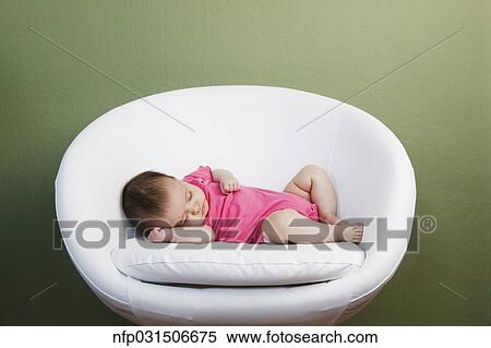 Baby sleeping on chair View Large Photo Image Stock Photography - Baby sleeping on chair. Fotosearch