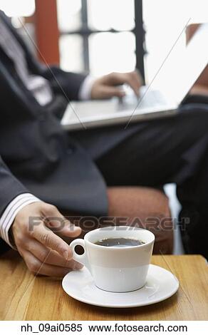 Businessman reaching for cup of coffee View Large Photo Image Stock Photography - Businessman reaching for cup of coffee. Fotosearch