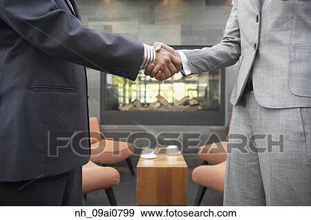Businesspeople shaking hands in cafe View Large Photo Image Stock Photo - Businesspeople shaking hands in cafe. Fotosearch