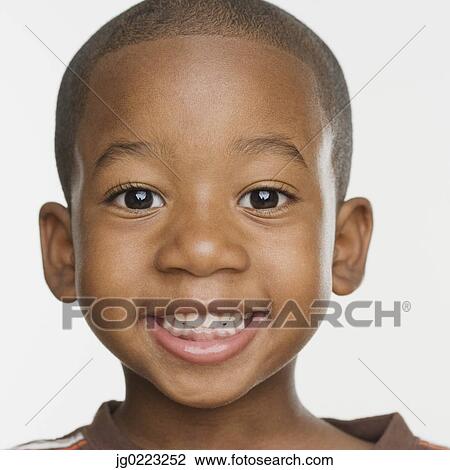 Stock Image - Close up of African boy smiling. Fotosearch