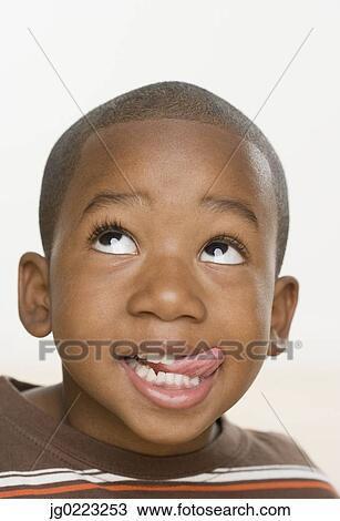 Close up of African boy sticking tongue out View Large Photo Image Stock Image - Close up of African boy sticking tongue out. Fotosearch
