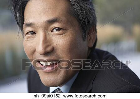Close up of Asian businessman smiling View Large Photo Image Stock Image - Close up of Asian businessman smiling. Fotosearch