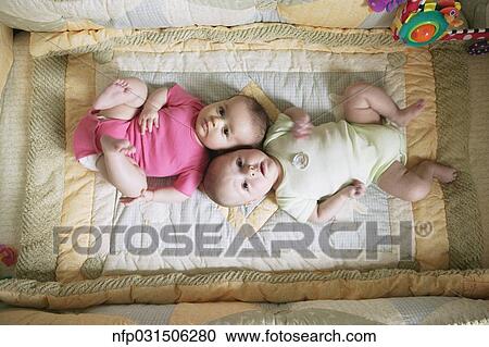 High angle view of two babies on blanket View Large Photo Image Stock Image - High angle view of two babies on blanket. Fotosearch
