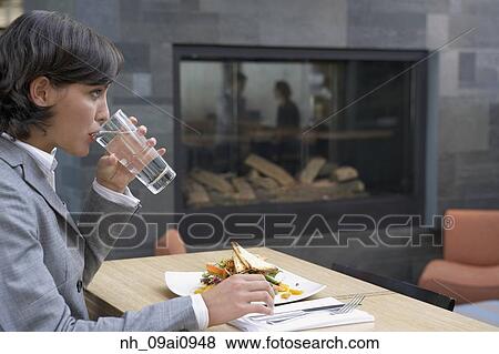 Hispanic businesswoman eating at restaurant View Large Photo Image Stock Photo - Hispanic businesswoman eating at restaurant. Fotosearch