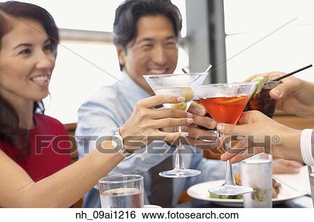 Multi-ethnic friends toasting at restaurant View Large Photo Image Stock Photograph - Multi-ethnic friends toasting at restaurant. Fotosearch