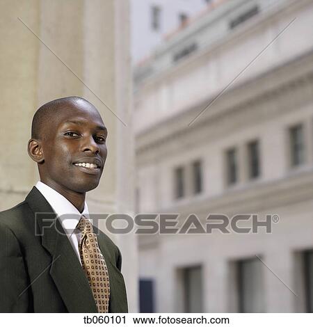 Portrait of African businessman in front of building View Large Photo Image Stock Image - Portrait of African businessman in front of building. Fotosearch
