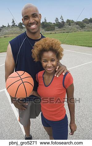 Portrait of African couple holding basketball View Large Photo Image Stock Image - Portrait of African couple holding basketball. Fotosearch