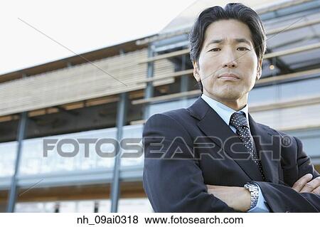 Portrait of Asian businessman with arms crossed View Large Photo Image Stock Photo - Portrait of Asian businessman with arms crossed. Fotosearch