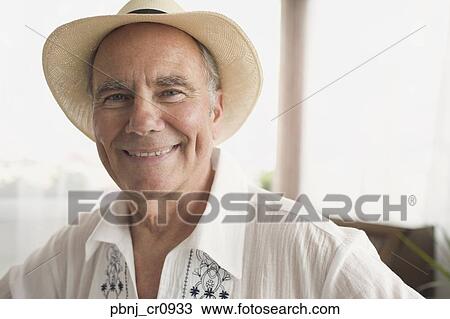 Stock Image - Portrait of senior man wearing hat. Fotosearch