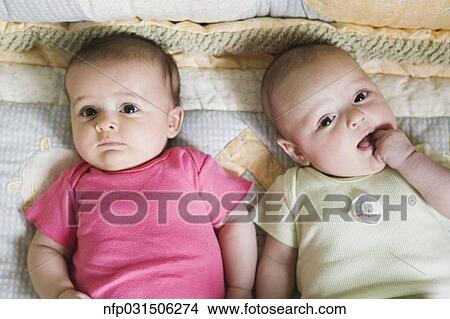 Portrait of two babies on blanket View Large Photo Image Picture - Portrait of two babies on blanket. Fotosearch