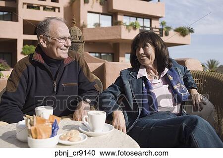 Senior couple eating at resort restaurant View Large Photo Image Stock Image - Senior couple eating at resort restaurant. Fotosearch