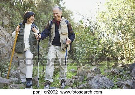 Senior couple hiking with poles View Large Photo Image Stock Image - Senior couple hiking with poles. Fotosearch
