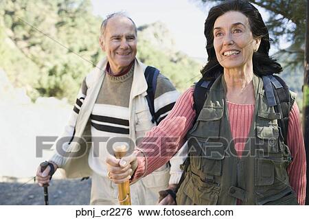 Senior couple hiking with poles View Large Photo Image Stock Image - Senior couple hiking with poles. Fotosearch - Search Stock Photography, Poster Photos, Pictures, and Photo Clip Art