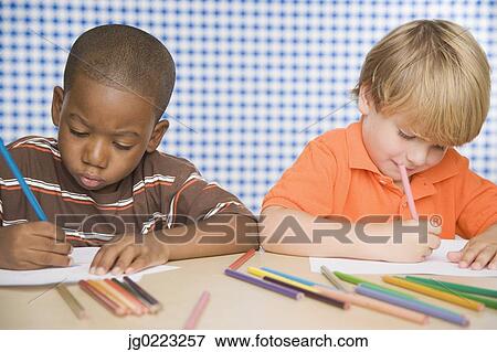 Stock Photo - Two young boys coloring. Fotosearch