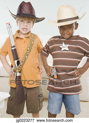 Stock Photo - Two young boys dressed as cowboys. Fotosearch