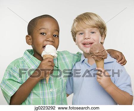 Two young boys eating ice cream cones View Large Photo Image Stock Image - Two young boys eating ice cream cones. Fotosearch
