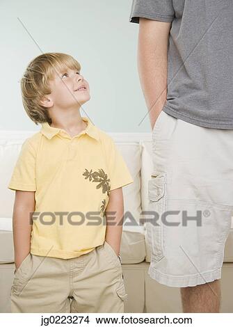 Picture - Young boy smiling up at father. Fotosearch