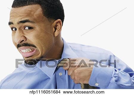 African businessman pulling at necktie View Large Photo Image Picture - African businessman pulling at necktie. Fotosearch