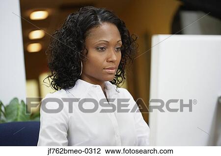 African businesswoman working at desk View Large Photo Image Stock Image - African businesswoman working at desk. Fotosearch