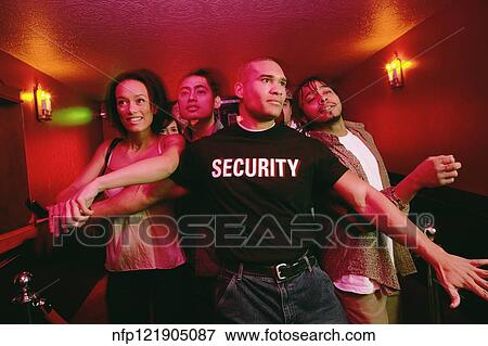 Stock Photo - African male bouncer holding back crowd of people. Fotosearch