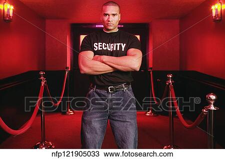 Stock Image - African male bouncer with arms crossed. Fotosearch