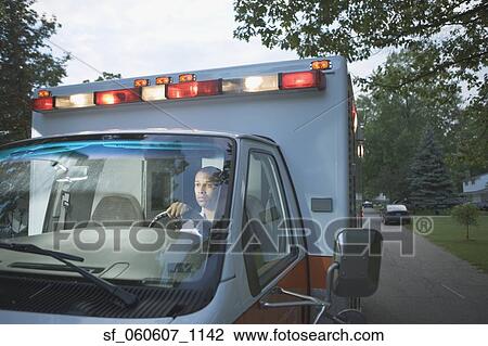 African male paramedic driving ambulance in residential area View Large Photo Image Stock Image - African male paramedic driving ambulance in residential area. Fotosearch