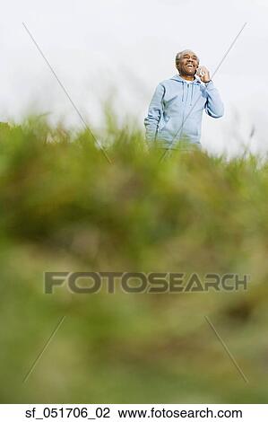 Stock Image - African man smiling outdoors. Fotosearch