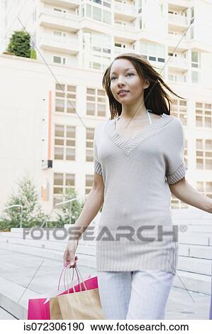 African woman carrying shopping bags View Large Photo Image Stock Image - African woman carrying shopping bags. Fotosearch