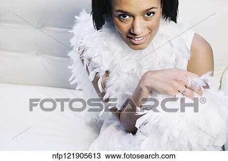 Stock Image - African woman wearing feather boa. Fotosearch