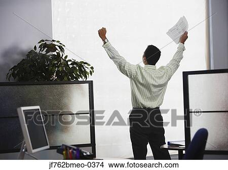 Asian businessman cheering in office View Large Photo Image Picture - Asian businessman cheering in office. Fotosearch