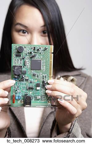 Asian businesswoman holding up computer circuit board View Large Photo Image Stock Image - Asian businesswoman holding up computer circuit board. Fotosearch