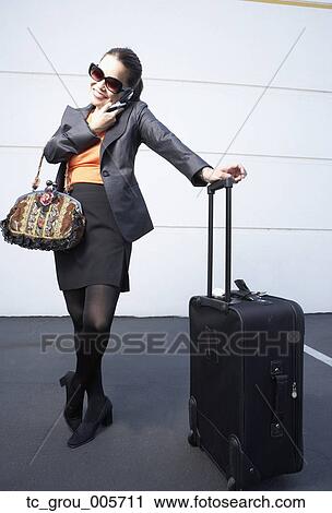 Stock Image - Asian businesswoman talking on cell phone. Fotosearch