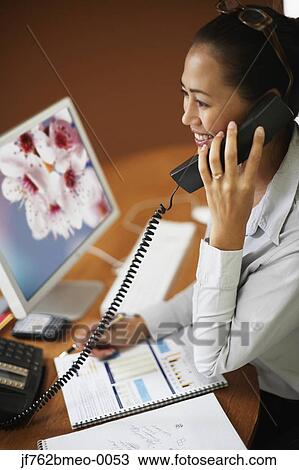 Asian businesswoman talking on telephone View Large Photo Image Stock Image - Asian businesswoman talking on telephone. Fotosearch