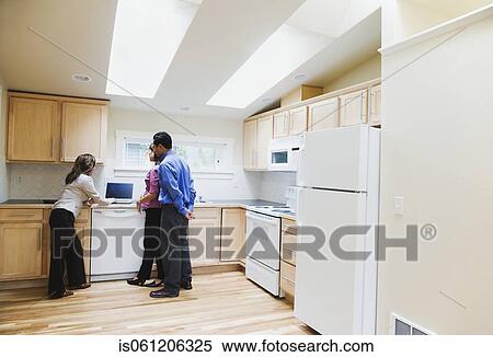 Asian couple looking at laptop with real estate agent View Large Photo Image Stock Photography - Asian couple looking at laptop with real estate agent. Fotosearch