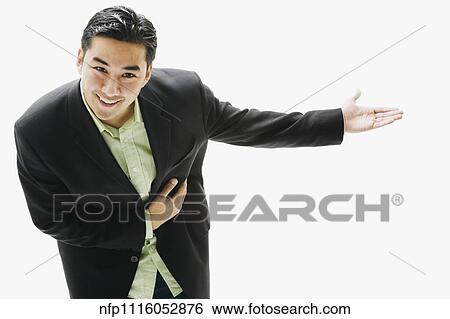 Asian Man Bowing With Arm Out Stock Photograph Nfp Fotosearch