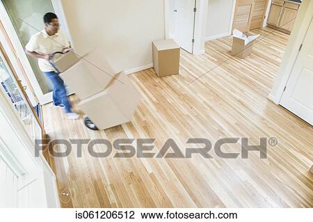 Asian man moving boxes in new house View Large Photo Image Stock Image - Asian man moving boxes in new house. Fotosearch
