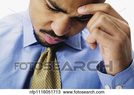 Close up of African businessman with head in hand View Large Photo Image Stock Image - Close up of African businessman with head in hand. Fotosearch