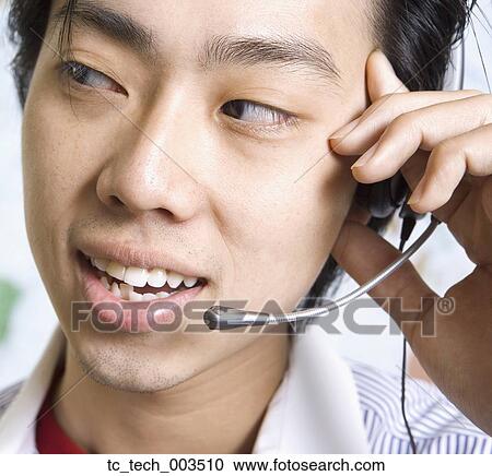 Close up of Asian businessman wearing headset View Large Photo Image Stock Image - Close up of Asian businessman wearing headset. Fotosearch