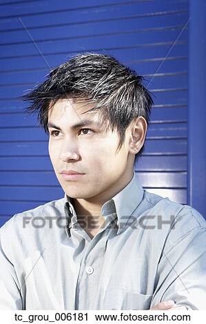 Stock Image - Close up of Asian man looking serious. Fotosearch