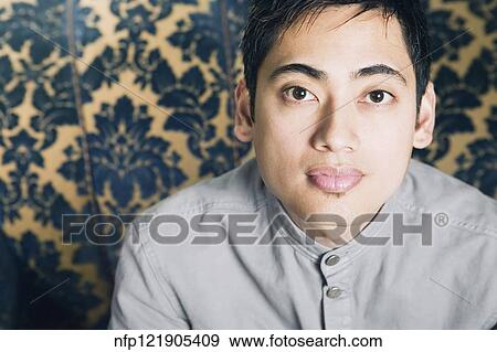 Close up of Pacific Islander man on sofa View Large Photo Image Stock Photo - Close up of Pacific Islander man on sofa. Fotosearch
