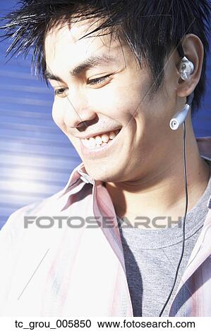 Close up of Pacific Islander man wearing hands free device View Large Photo Image Stock Image - Close up of Pacific Islander man wearing hands free device. Fotosearch