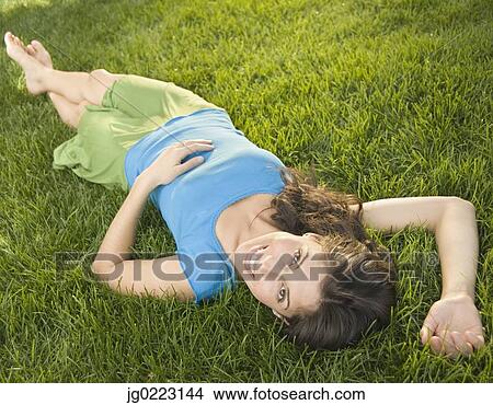 Hispanic woman laying in grass View Large Photo Image Picture - Hispanic woman laying in grass. Fotosearch