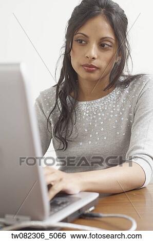 Middle Eastern businesswoman typing on laptop View Large Photo Image Stock Photograph - Middle Eastern businesswoman typing on laptop. Fotosearch