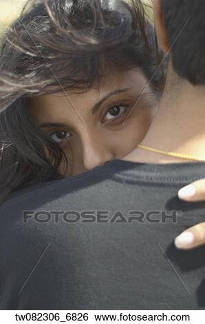 Middle Eastern woman looking over man's shoulder View Large Photo Image Stock Photograph - Middle Eastern woman looking over man's shoulder. Fotosearch